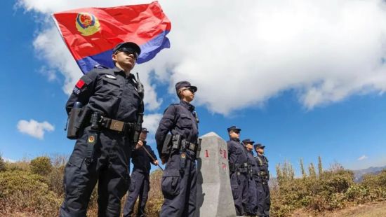 云南边检总站民警在“共和国1号界碑”旁与警旗同框。资料图 云南边检总站民警在“共和国1号界碑”旁与警旗同框。资料图